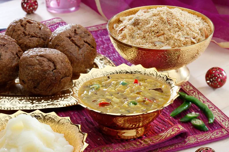 Traditional Indian Rajasthani meal with dal baati churma served in golden bowls